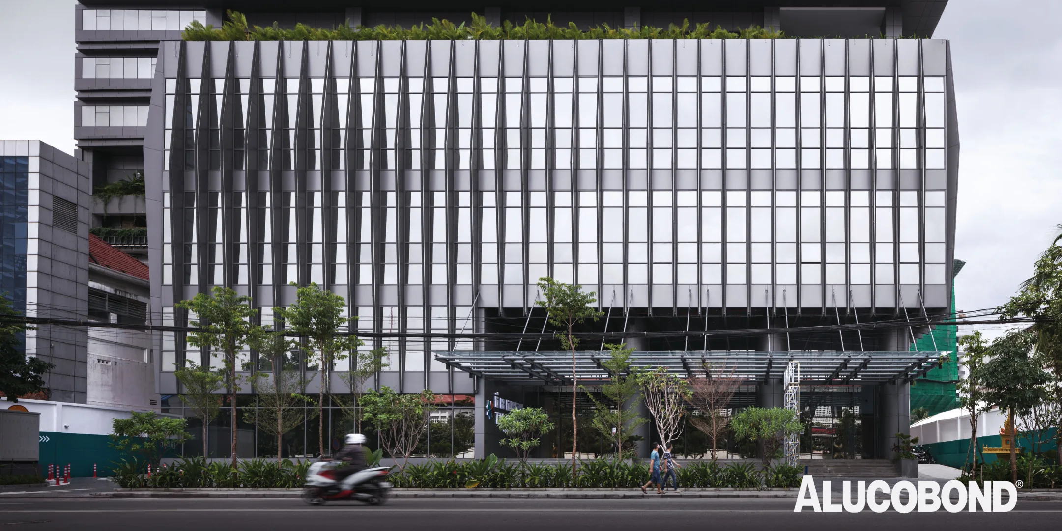TK Central building in Phnom Penh, Cambodia, showcasing vertical ALUCOBOND PLUS 4mm fins in Grey Metallic 502 designed for solar heat gain reduction.
