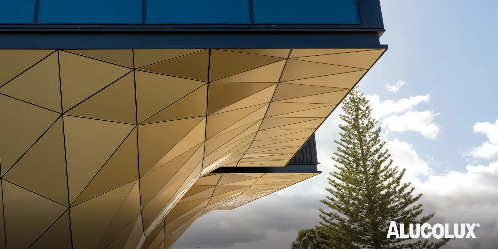 Exterior of The Pullman Hotel featuring ALUCOLUX Gold Metallic solid aluminium panels, designed by Warren & Mahoney and installed by Symonite Panels Ltd, completed in 2022.